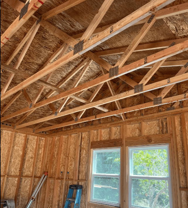 an attic structure of walls and wood ceiling and walls with window