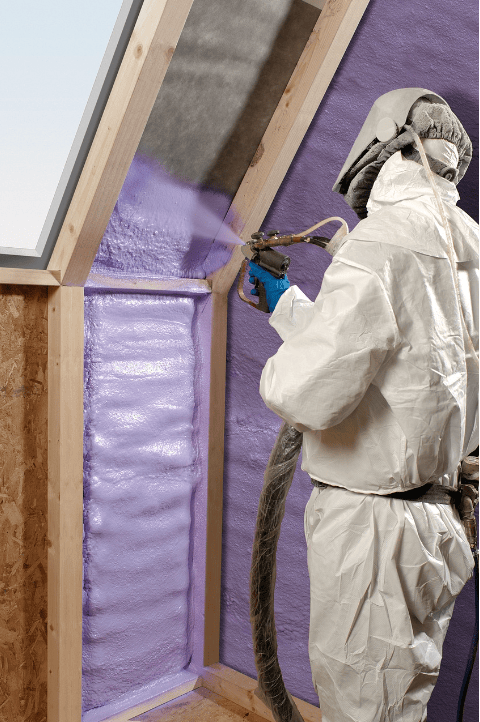 person in safety gear spraying spray foam insulation for installation